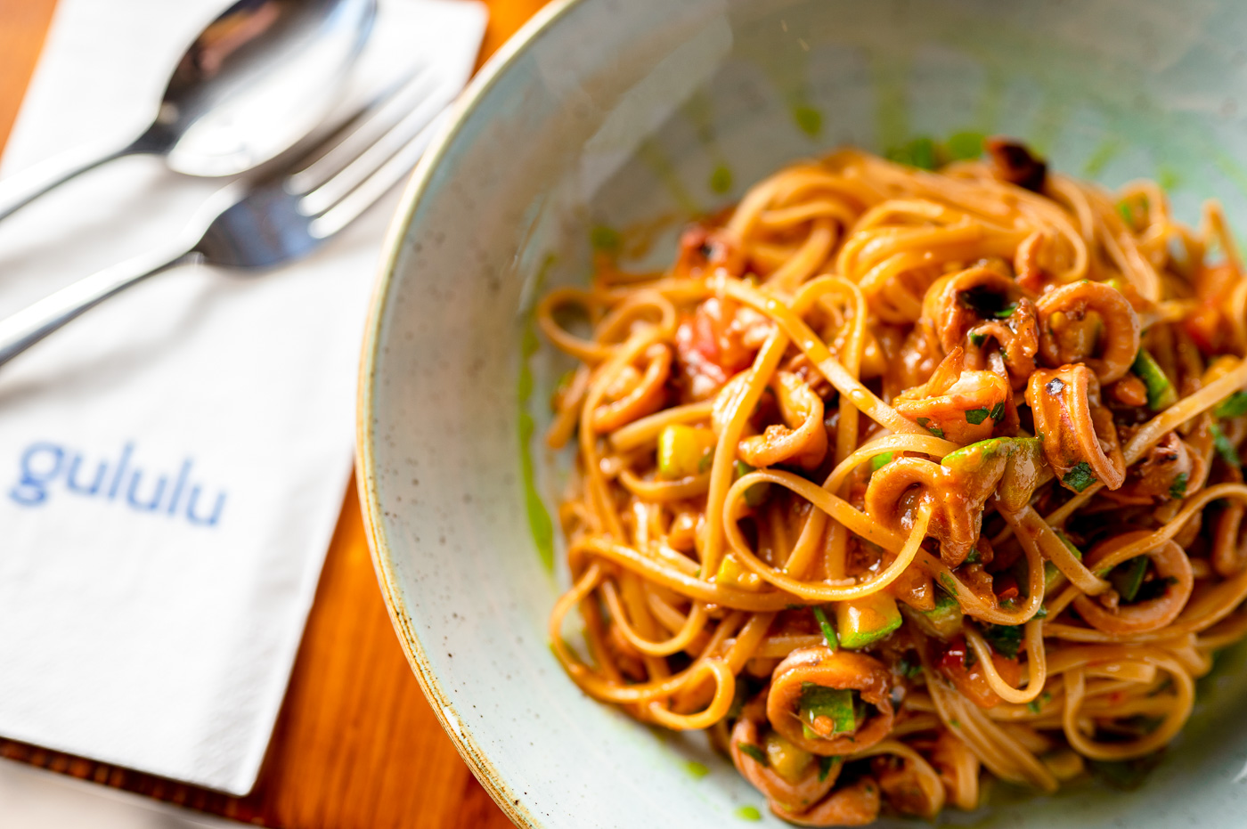 Gululu's signature Spaghetti Rabbit, plated in a sage bowl
